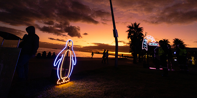 Neon Penguin and neon St Kilda sign from Southside Live music festival