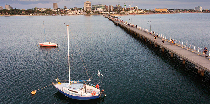 View of two boats moored near a pier on a calm day
