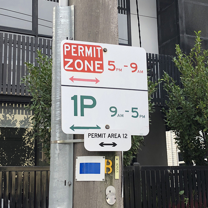 Parking sign for a permit zone from 5 pm to 9 am all days and 1P from 9 am to 5 pm.